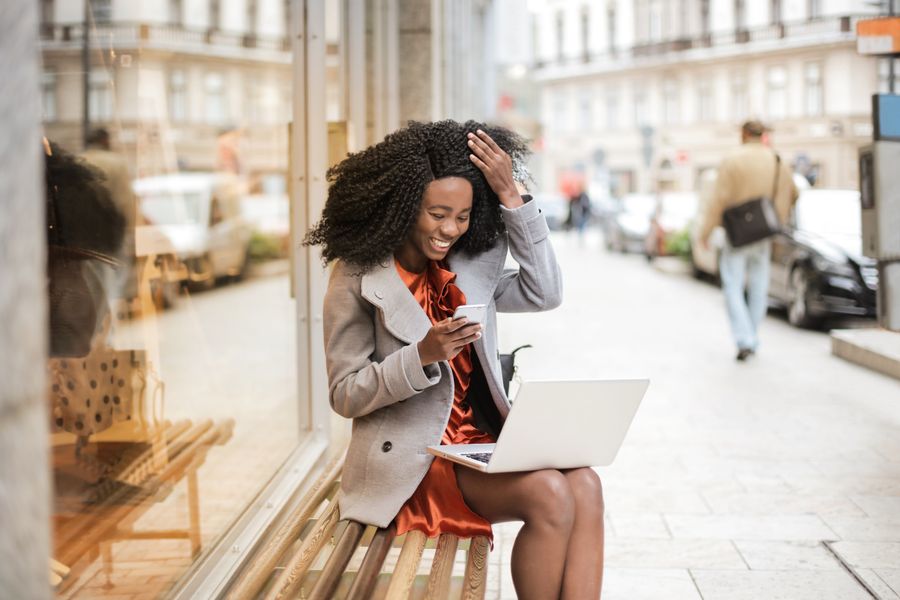 A woman working on a laptop in a cafe