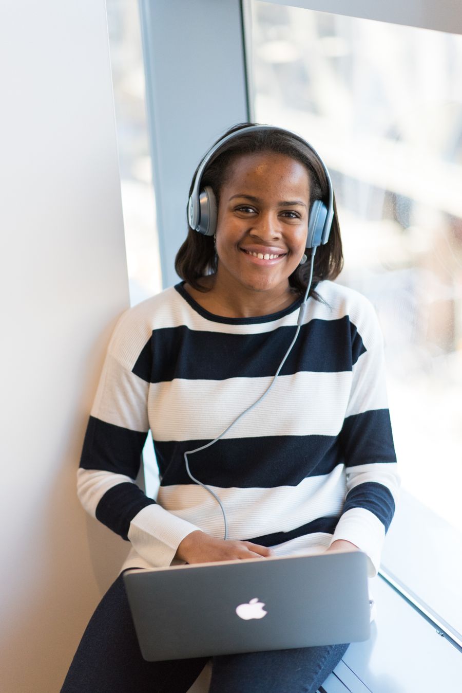 A woman smiling while using her laptop